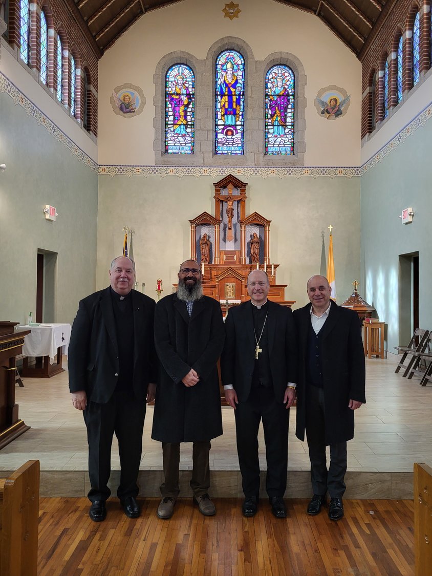 Monsignor Robert A. Kurwicki VG; Rami Salfiti; Bishop W. Shawn McKnight; and Moses Jarjoui gather in the sanctuary of St. Stanislaus Church in Wardsville Feb. 5 after a presentation given by Mr. Salfiti to members of the Equestrian Order of the Holy Sepulchre of Jerusalem.